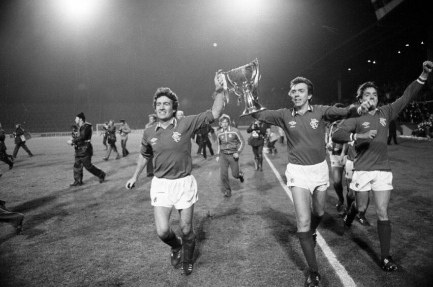 Rangers players Jardine, Miller and Ian Redford celebrate with the trophy at full time.