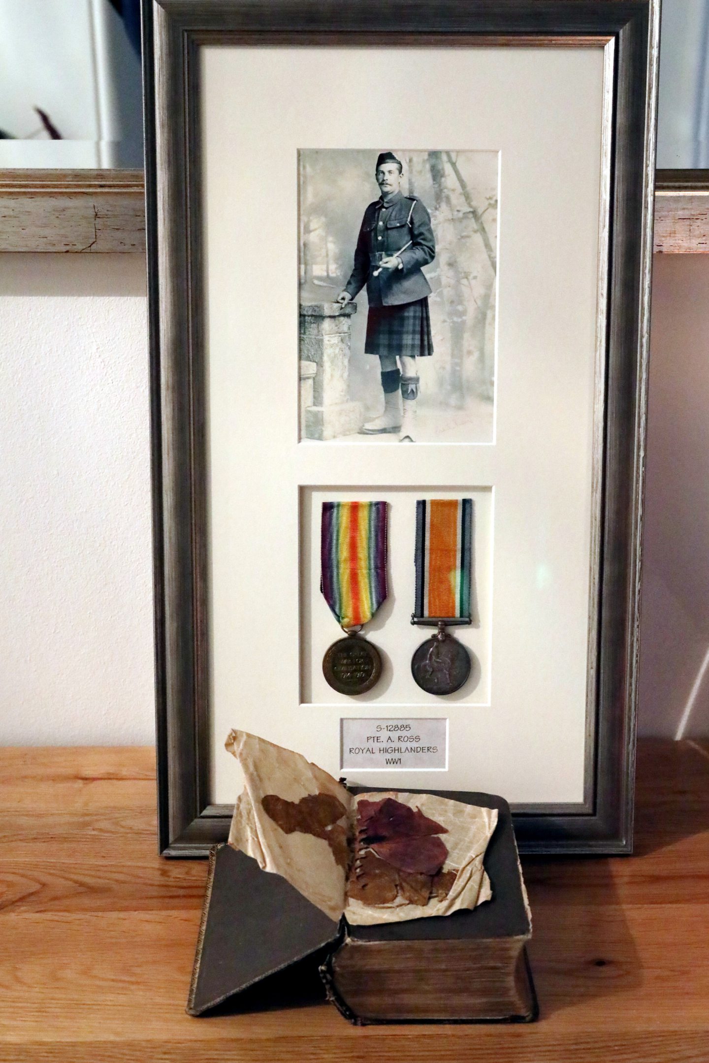 A framed picture of Pte Ross and the poppy kept by the Angus family.