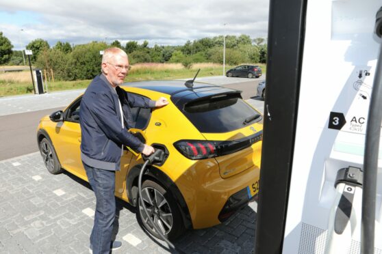 Mike Devine electric car charging in Forfar.