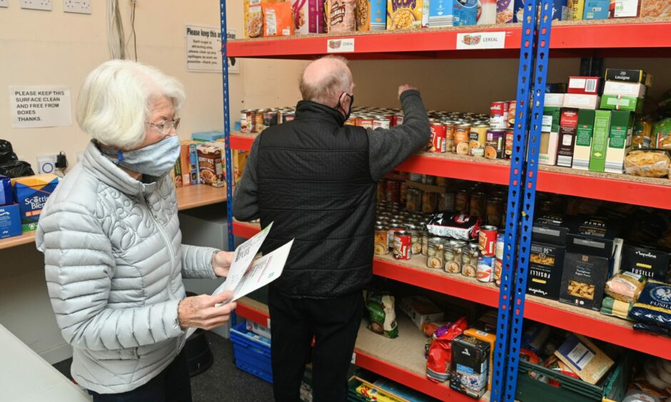 Volunteers Jan Harrell and George Paul packing food parcels at Moray Food Plus.