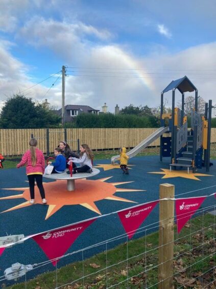 Children play on the new roundabout
