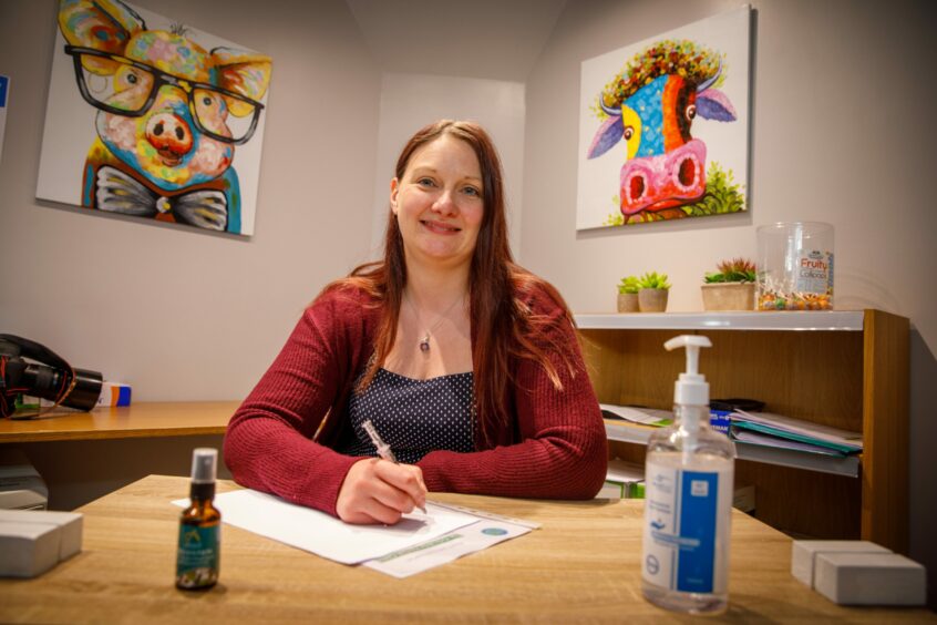 Female doctor at desk.