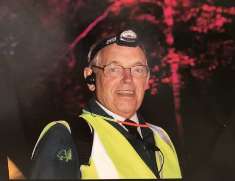 wearing a head lamp and yellow high visibility jacket, Michael Cheesewright is pictured at Faskally Enchanted Forest