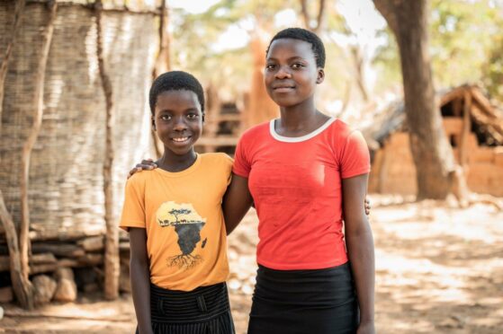 Two school-age sisters in Africa who have been helped by Mary's Meals