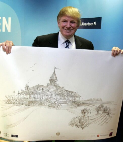 Donald Trump holding a plan for his new clubhouse in 2006.