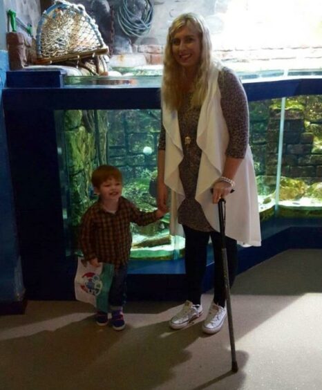Paula Leask visits an aquarium with son William. 