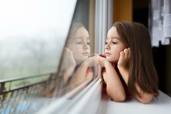 A little girl looking out of the window