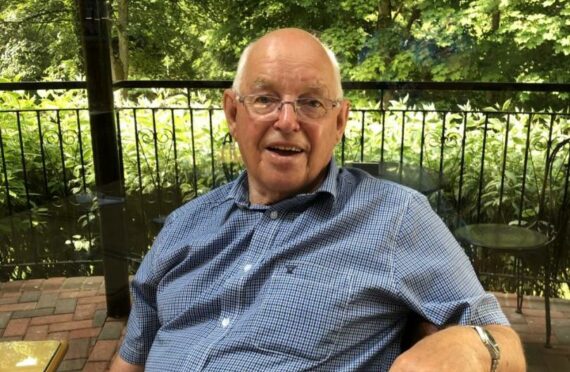 Michael Cheesewright sitting on a patio in Pitlochry