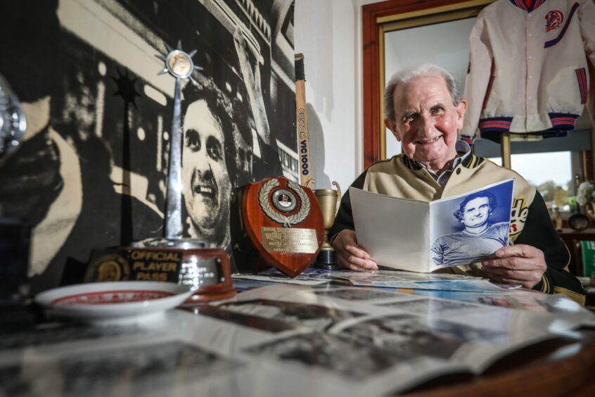 George Reid at home in Broughty Ferry looking back at his Dundee Rockets ice hockey memorabilia.