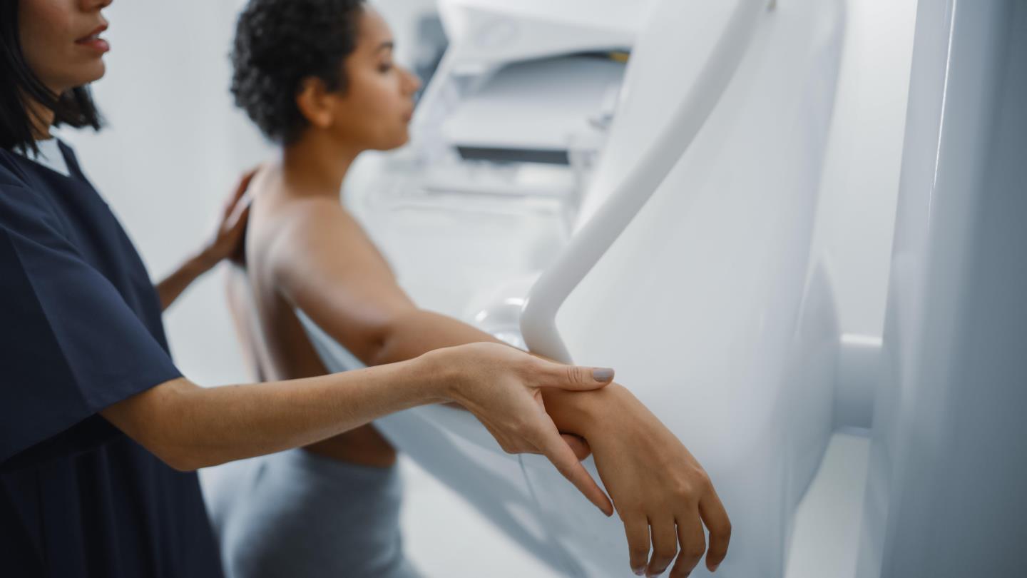 A woman receives a mammogram