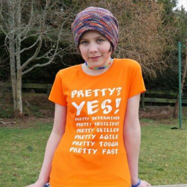 A girl modelling scarf monkey clothing - an orange t shirt