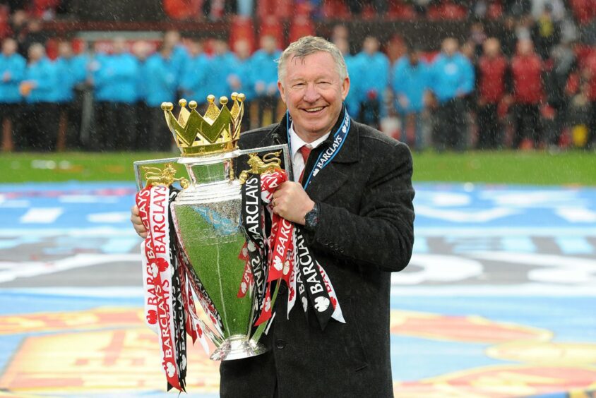 alex ferguson holding the premier league trophy