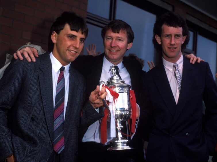 Aberdeen's John Hewitt, manager Alex Ferguson and Billy Stark celebrate winning the 1986 Scottish Cup with Aberdeen.