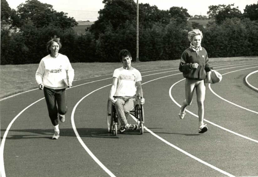 Danny training at Caird Park with his coach Barbara Oliver (left) and Catriona Williams of Hawkhill Harriers.