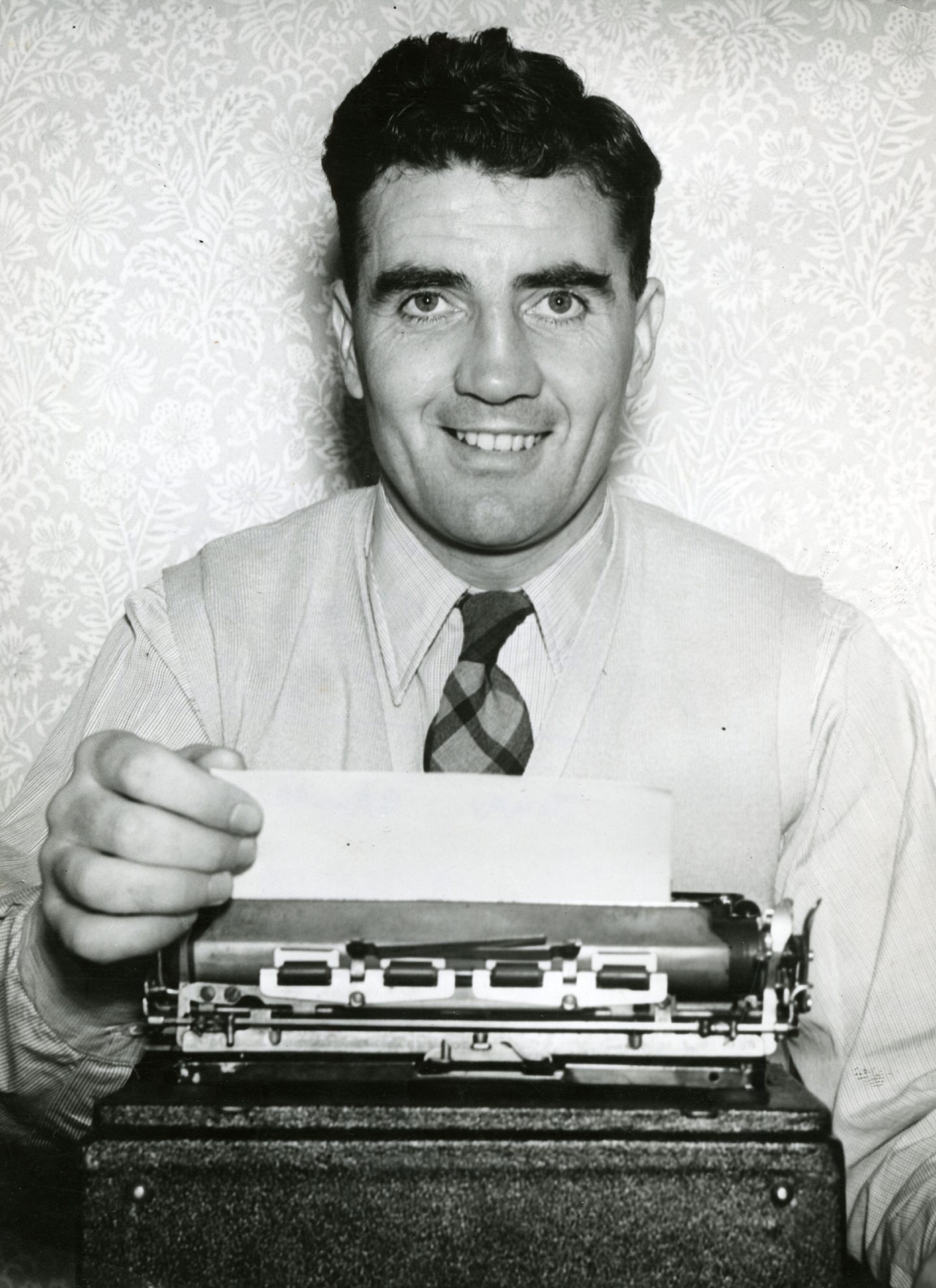 Tommy Gallacher at the typewriter in 1955. Picture: DCT Media.