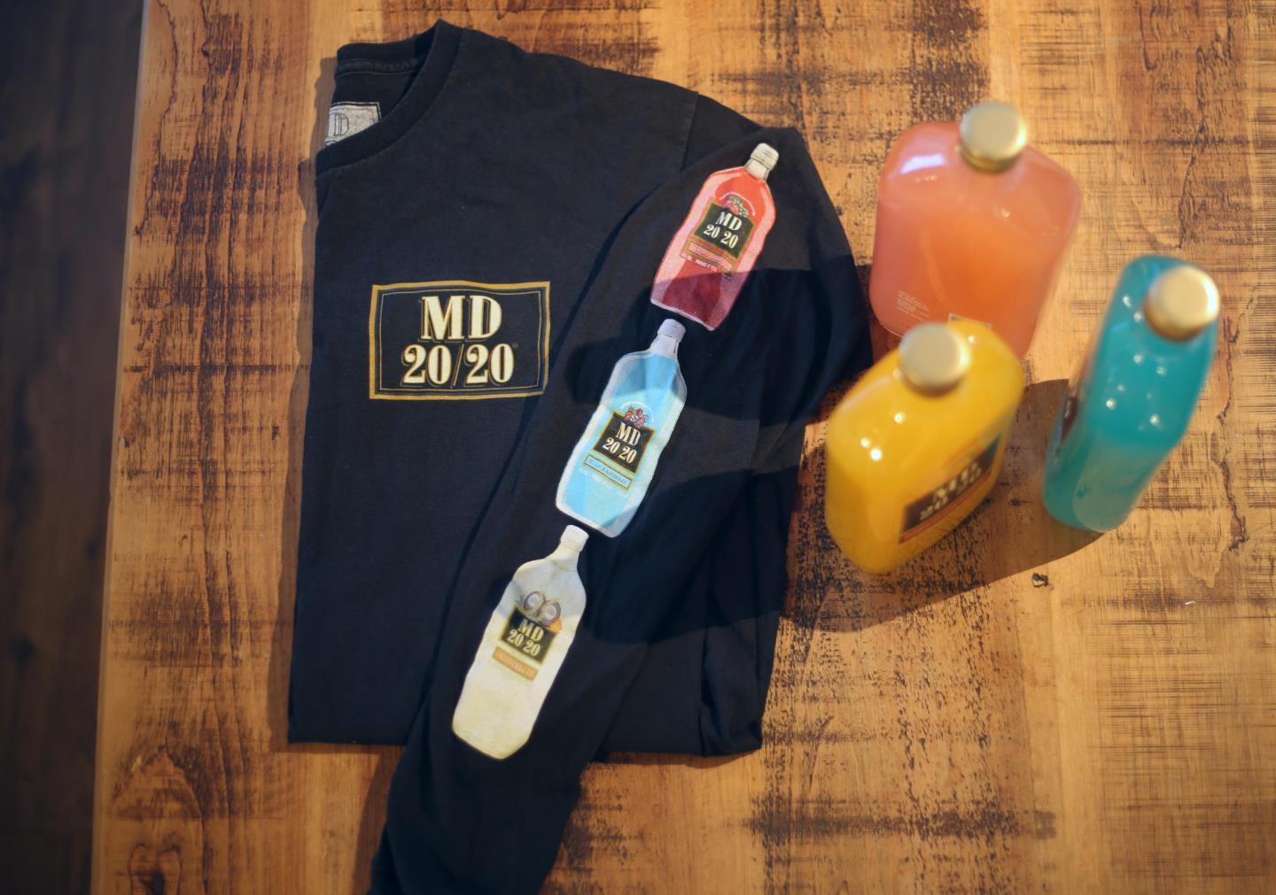 three bottles of mad dog MD 20/20 next to a MD 20/20 T-shirt