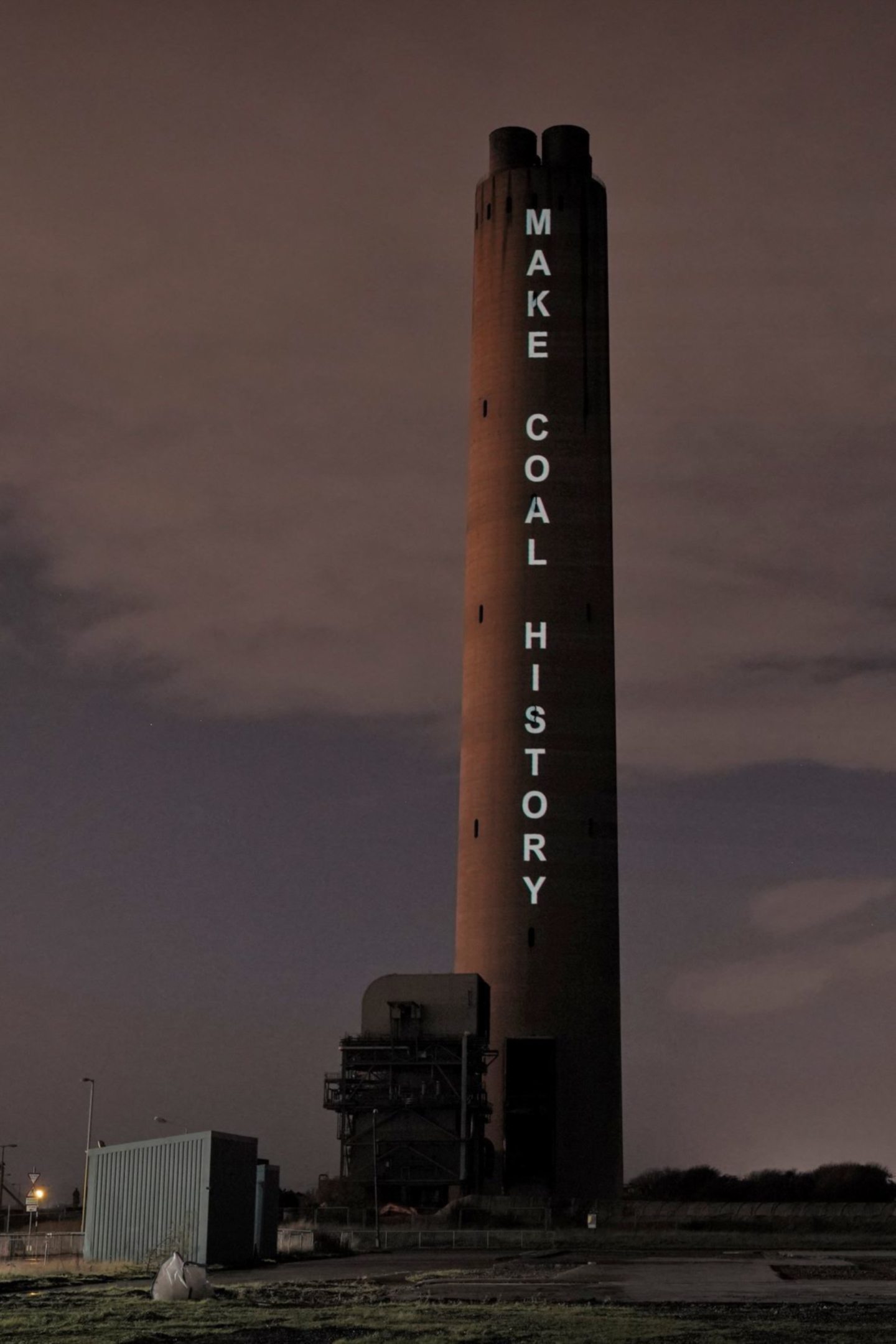 The chimney at Longannet, with Make Coal History projected on it.