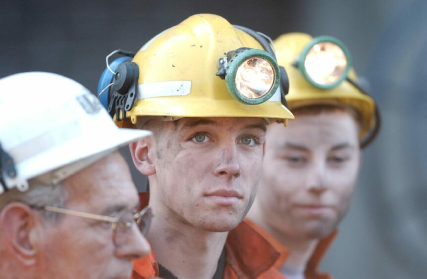 An apprentice, 16-year-old Scott Hunter, from Rosyth, with his pit helmet on.