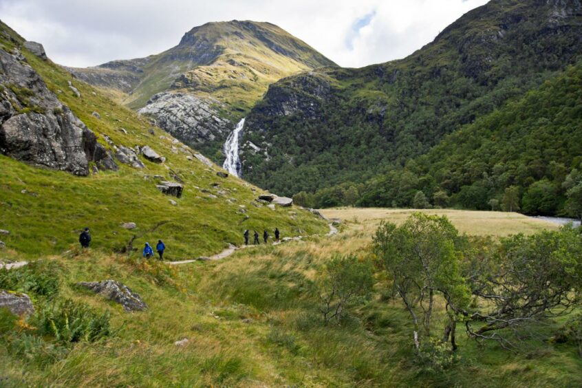 Steall Falls with some walkers in the distance