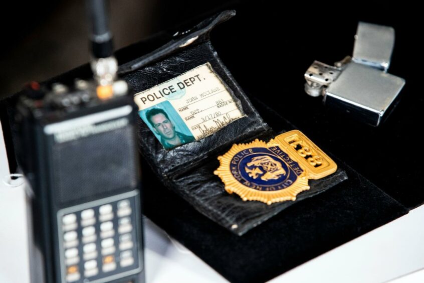 Film props: John McClane's badge, lighter and walkie talkie 