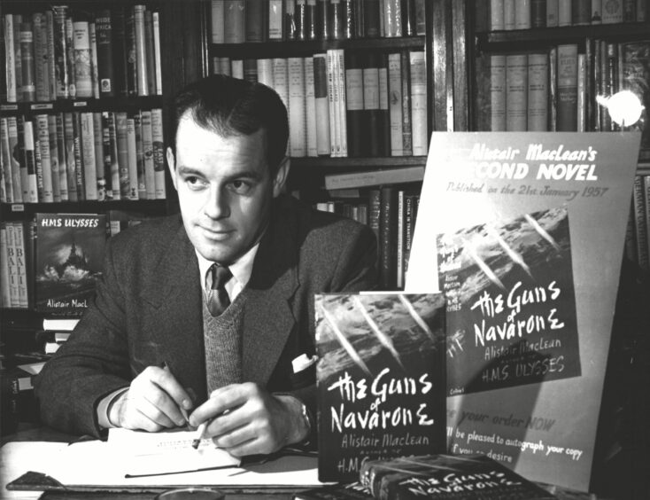 Alistair MacLean signing novels in a bookshop