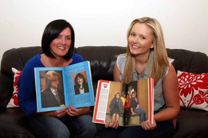 Michelle and daughter Chloe looking back through old magazines back in 2011. Photo: DCT Media.