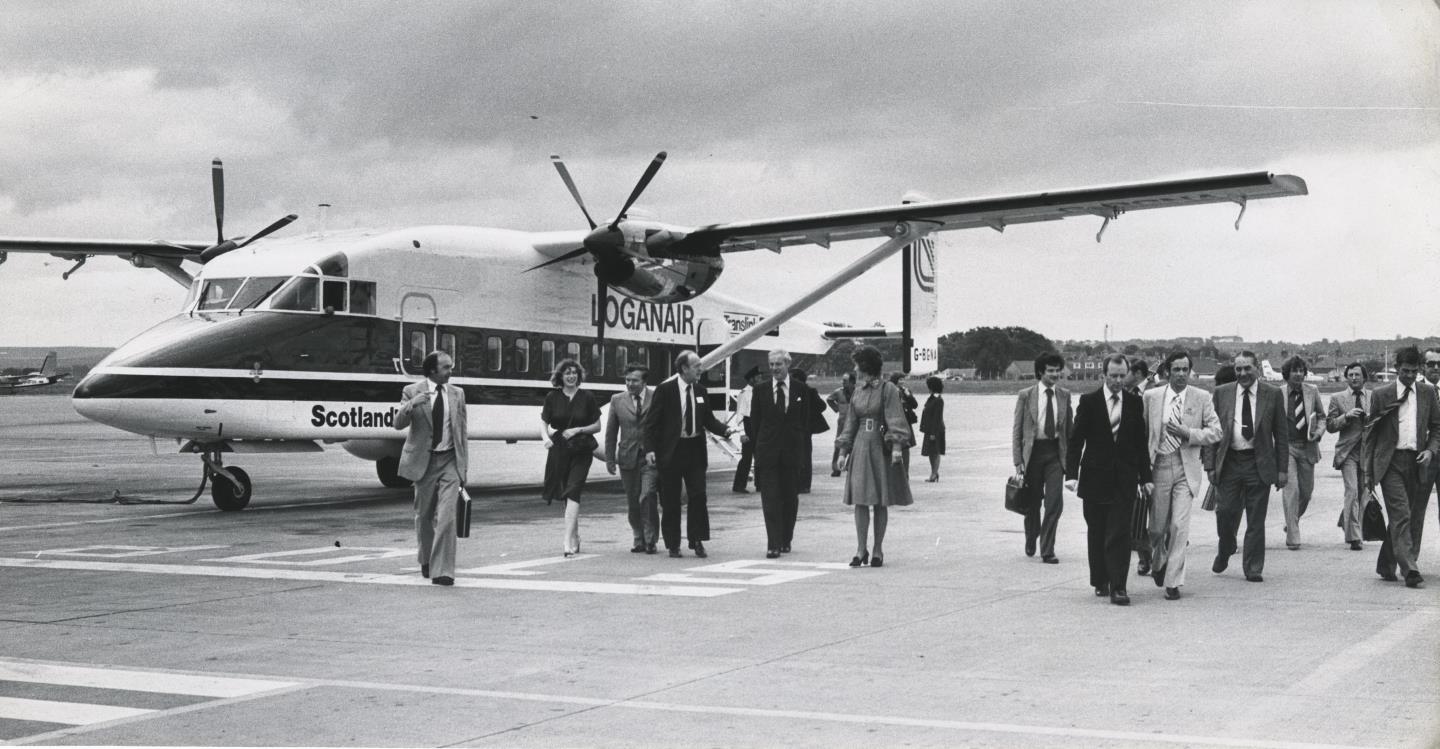 Passengers depart from a Loganair aircraft.
