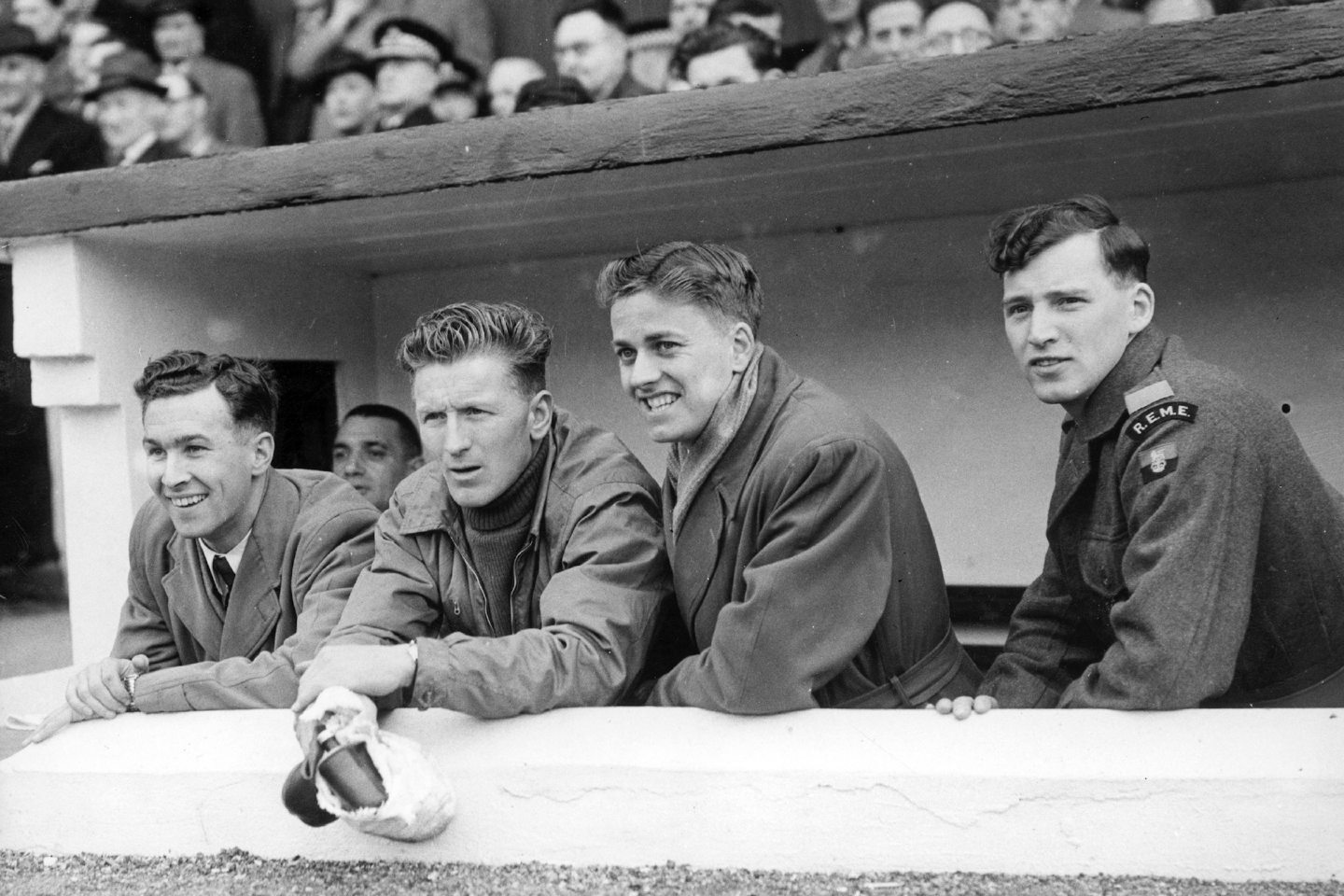 Bobby Wishart, newly-appointed manager Davie Shaw, Harry Yorston and Hughie Hay peer out from the Pittodrie dug-out in 1955.