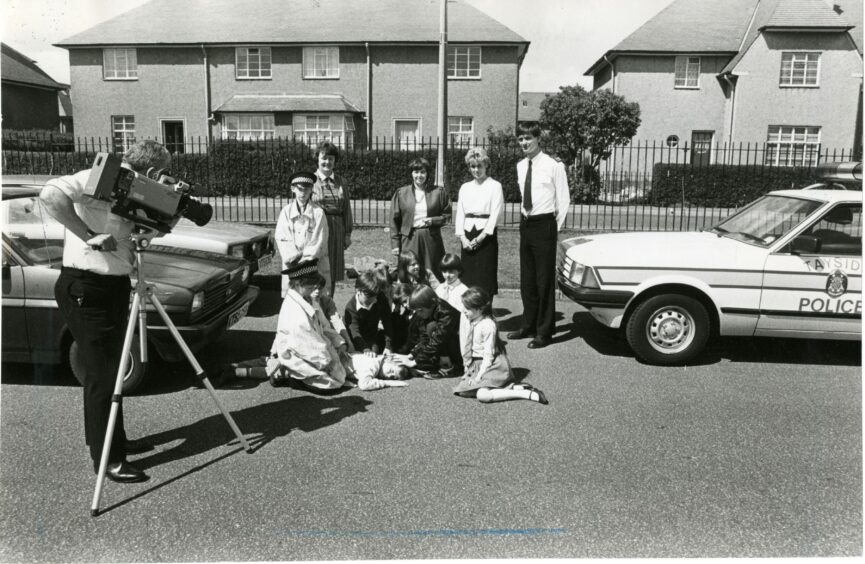 Primary six pupils of Gilburn school being filmed during a road safety event in 1986. Teaching staff from left are,  Gloria Anderson; Glenys Marra (Tayside Region Primary Computing Team) and Marion Geddes.
