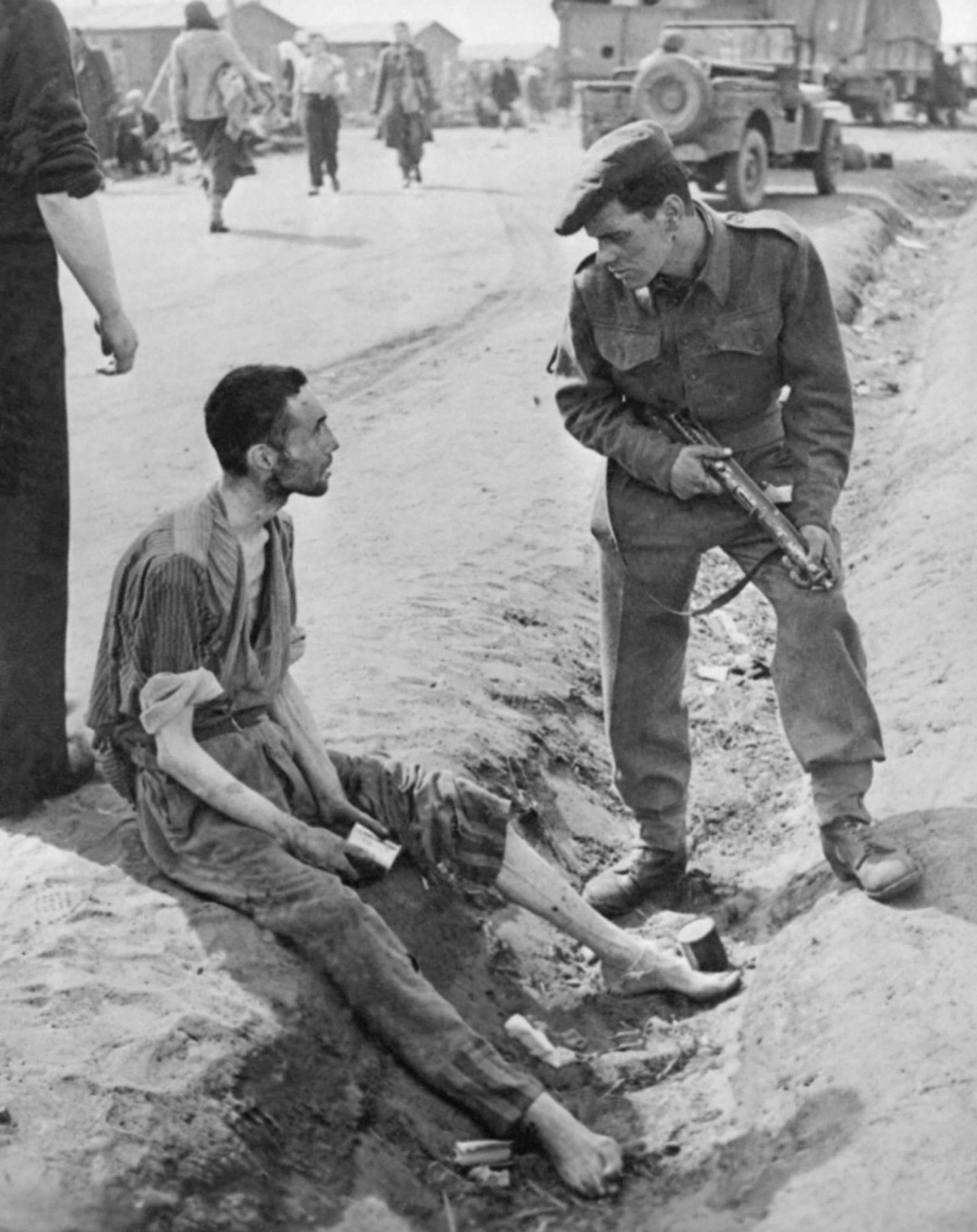 A British soldier talking to an inmate at Belsen.