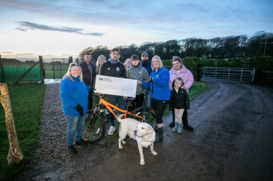 Sammy presenting his cheque to the rescue centre.