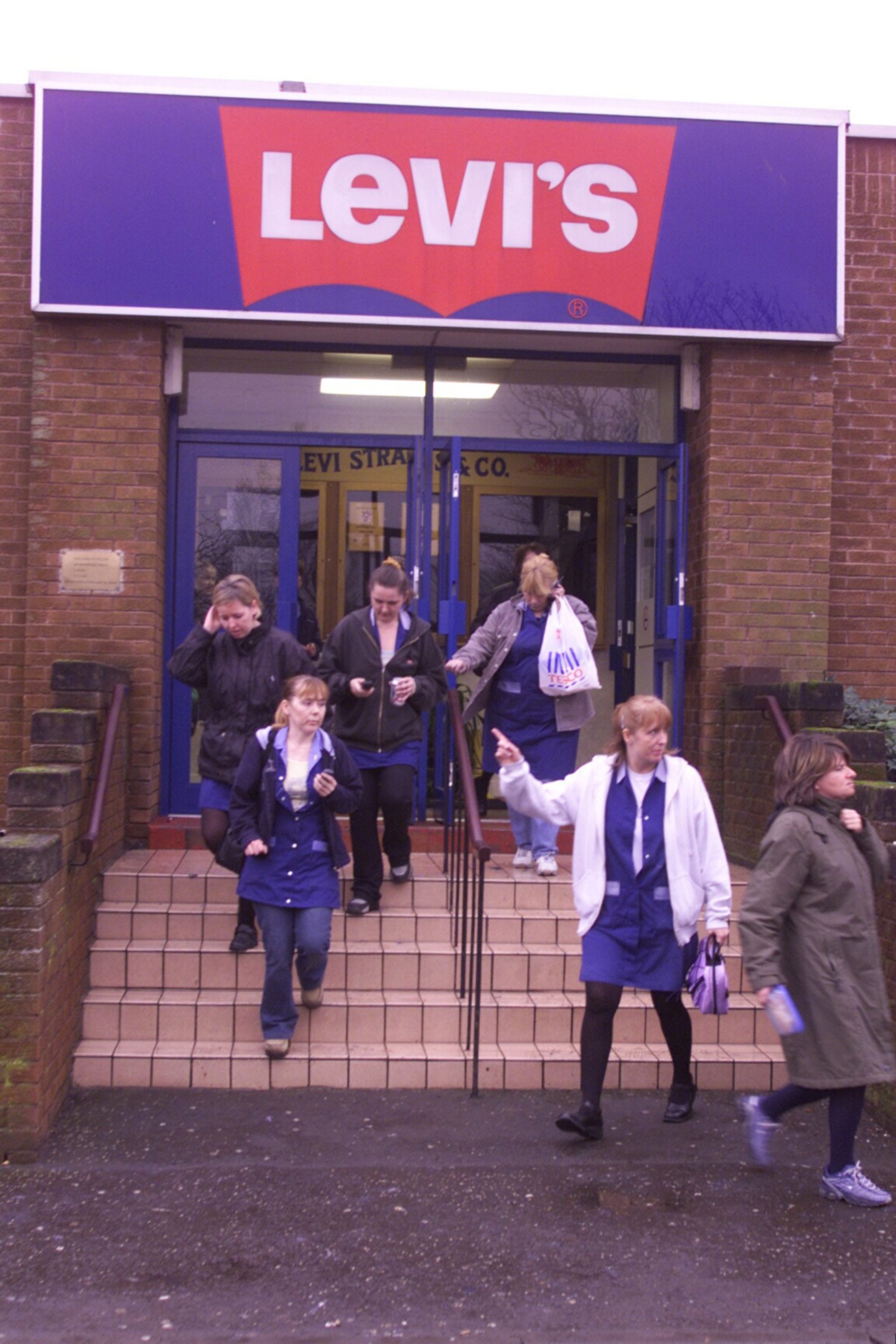 Workers leaving the Levi's factory after being given the news in January 2002.