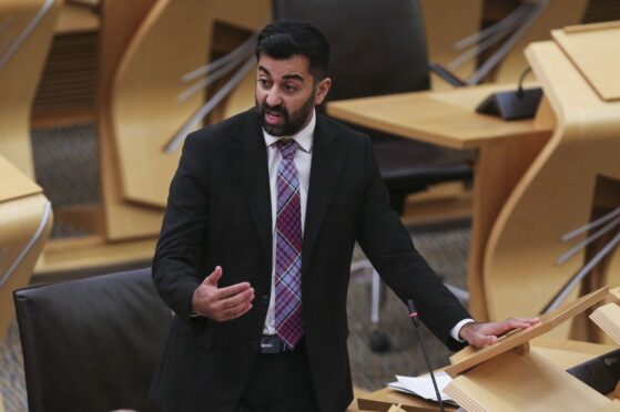 Health Secretary Humza Yousaf discussing the breast cancer scandal in parliament