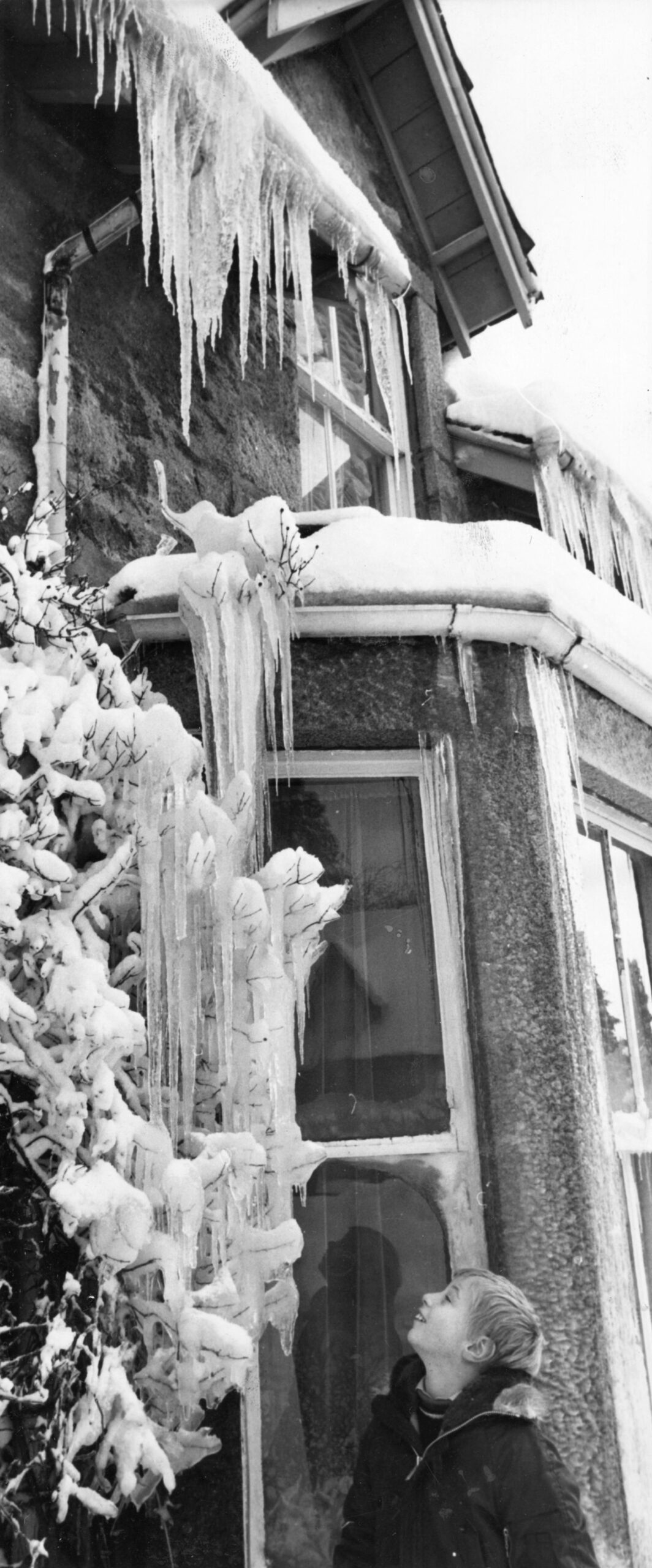 Nine-year-old John Rowell, from Torquay, who was among those left stranded, looks at the display of ice outside one of the houses on Braemar's main street. Picture: DCT Media.