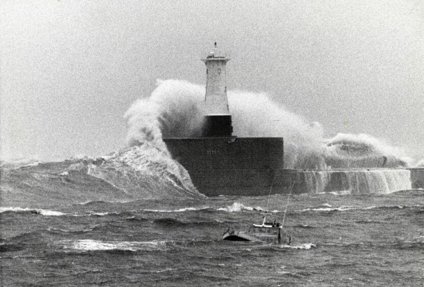 Waves break over a lighthouse