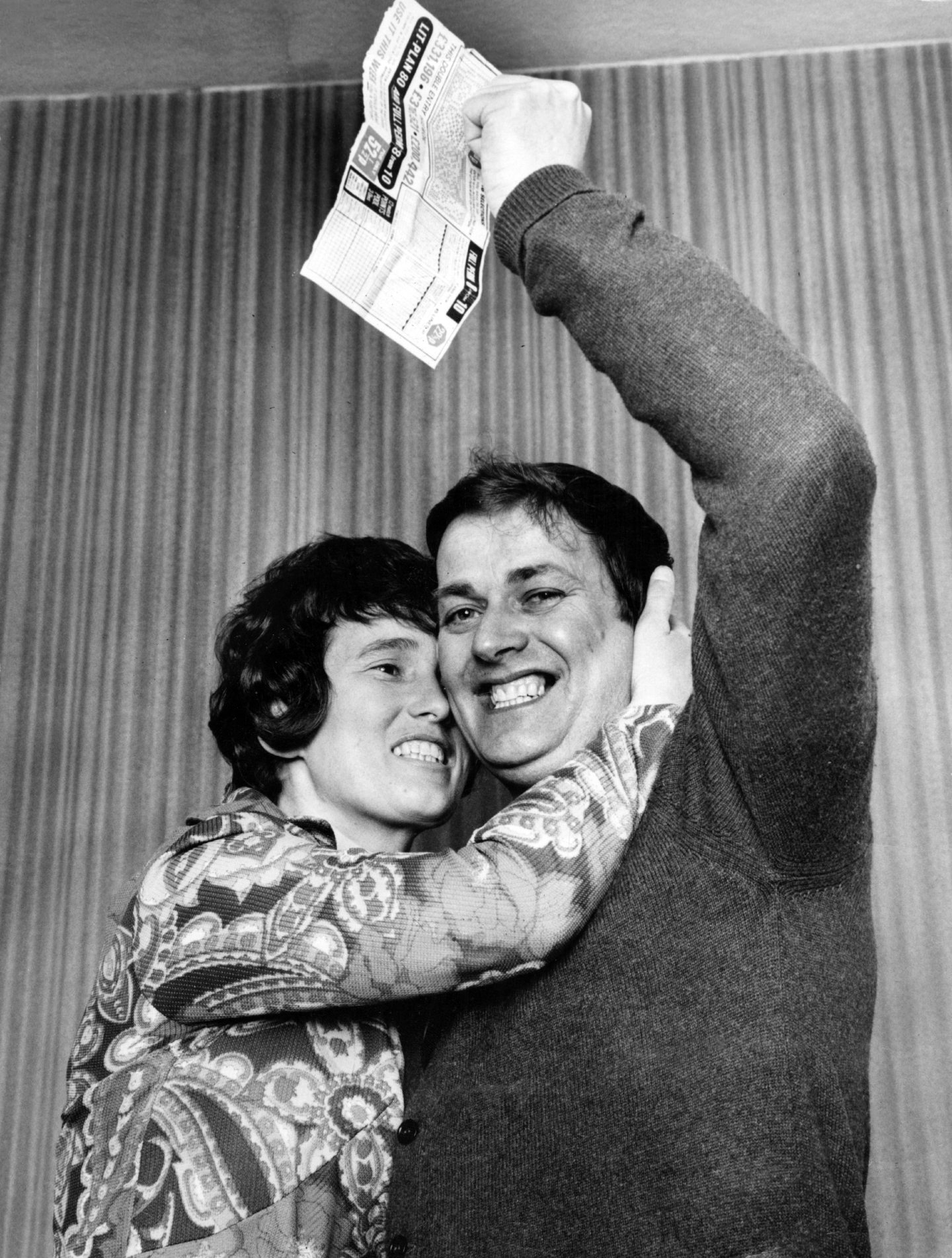 A happy Harry Yorston, his coupon held aloft, gets a big hug from his wife Johan on hearing the wonderful news.
