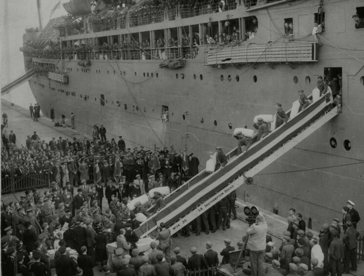 The P&amp;O liner Corfu at Southampton with the first shipload of prisoners of war recently freed from Japanese camps. Northcliffe Collection.