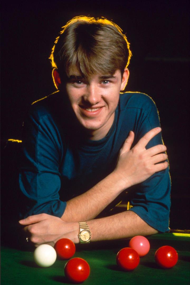 A young Stephen Hendry poses by a snooker table