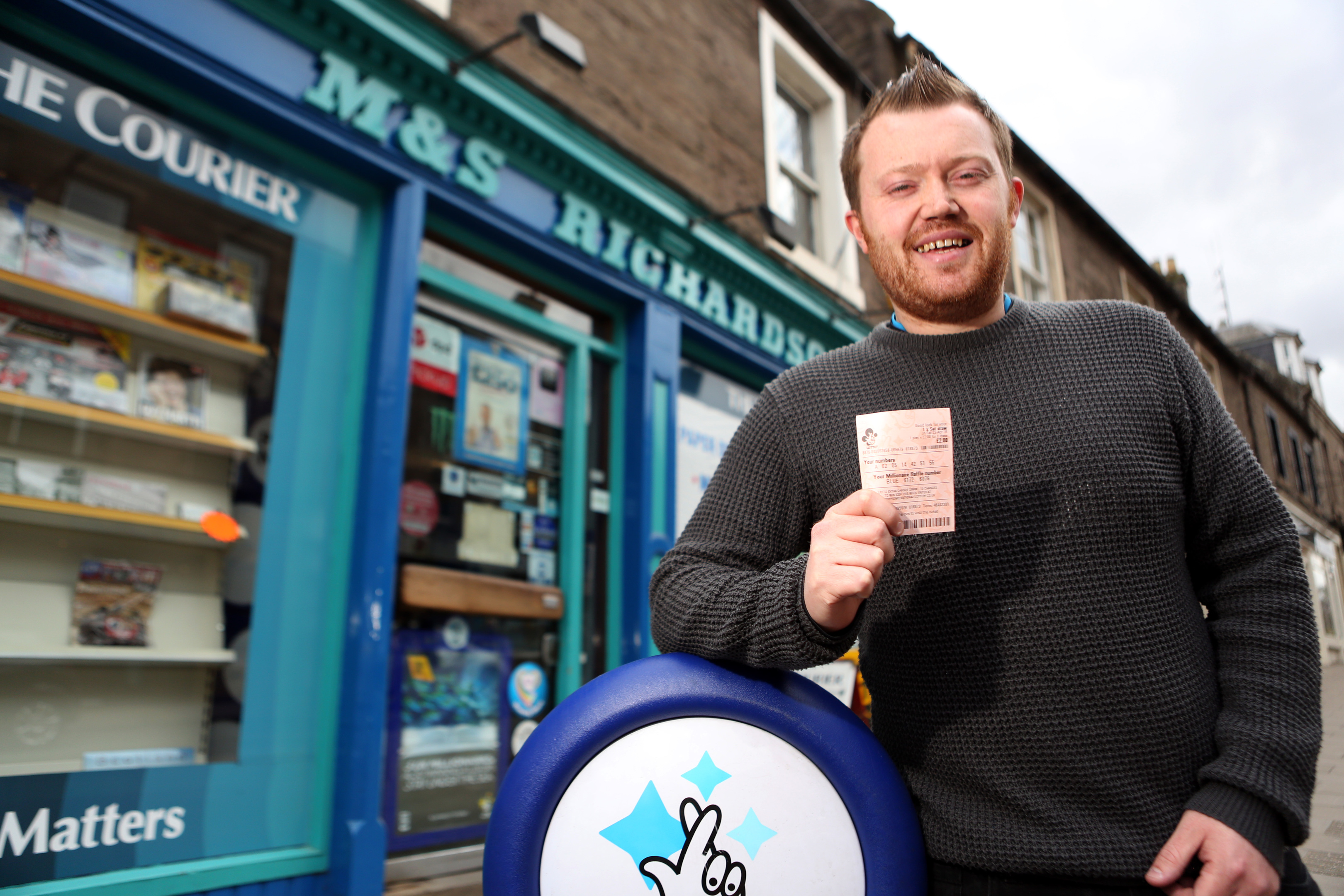 Clive Myles  with his ticket outside Richardson's in Forfar