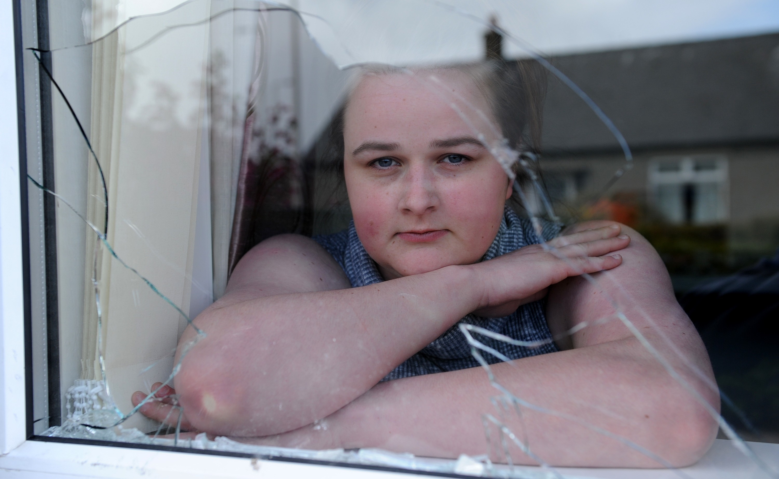 Richard Caffrey's partner Stacey Barrett with one of the broken windows.