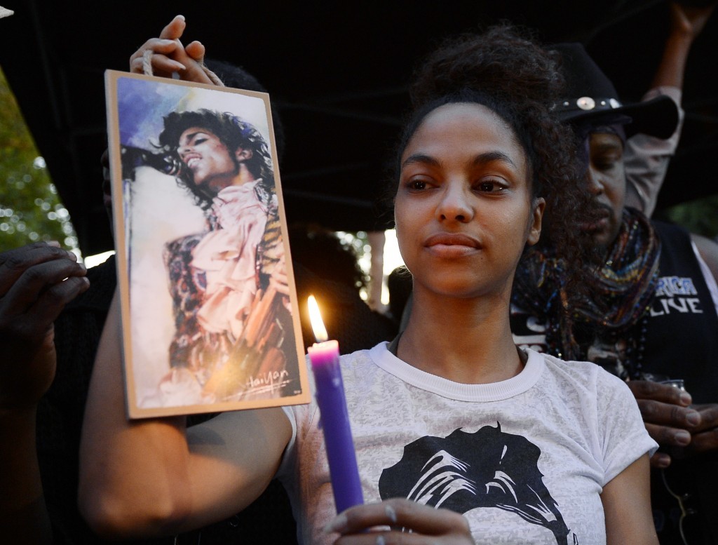 Julya Baer, 30, cries during a candlelight vigil in Leimert Park in Los Angeles.