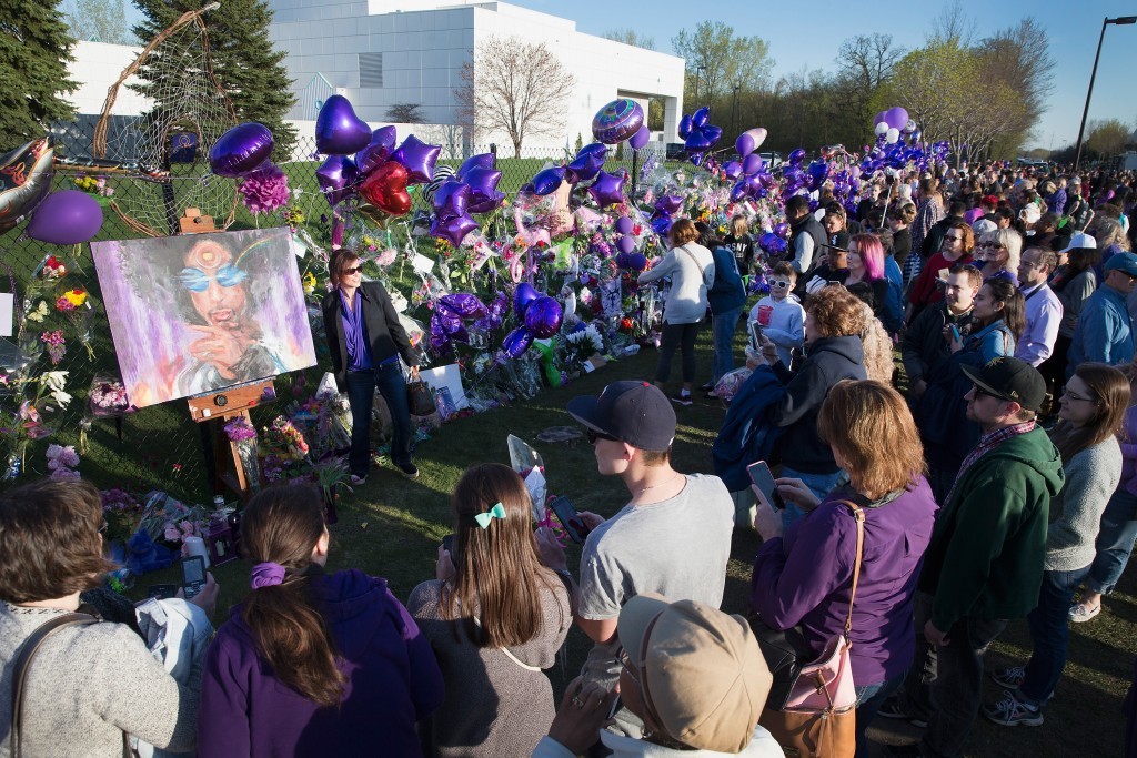 Music fans visit a memorial outside Paisley Park, the home and studio of Prince.