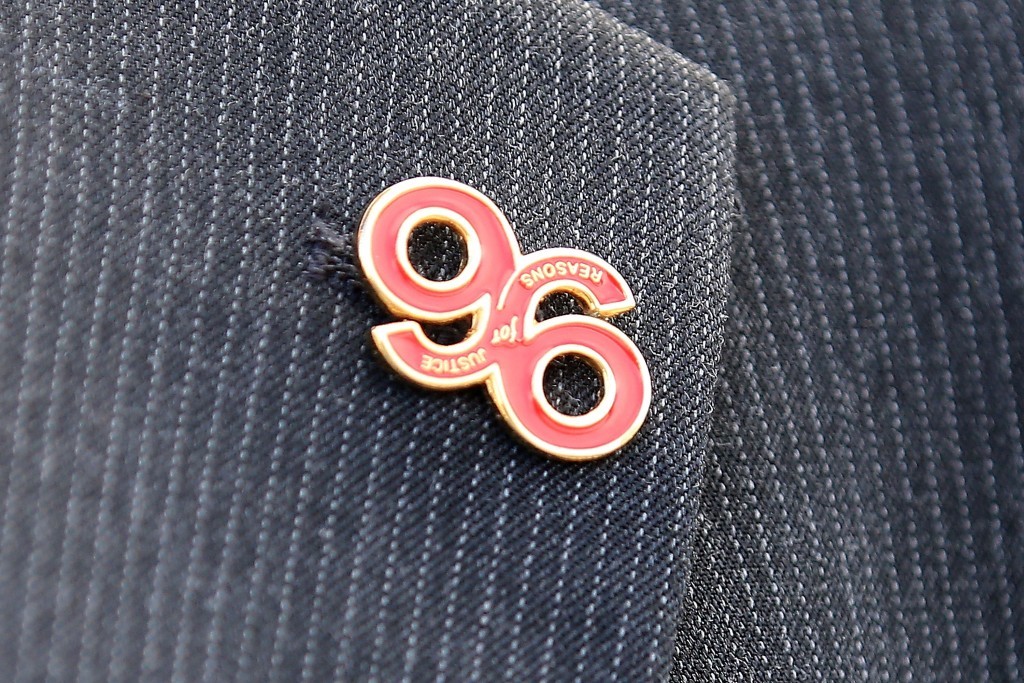 A relative arrives, wearing a 'Justice for the 96' button badge.