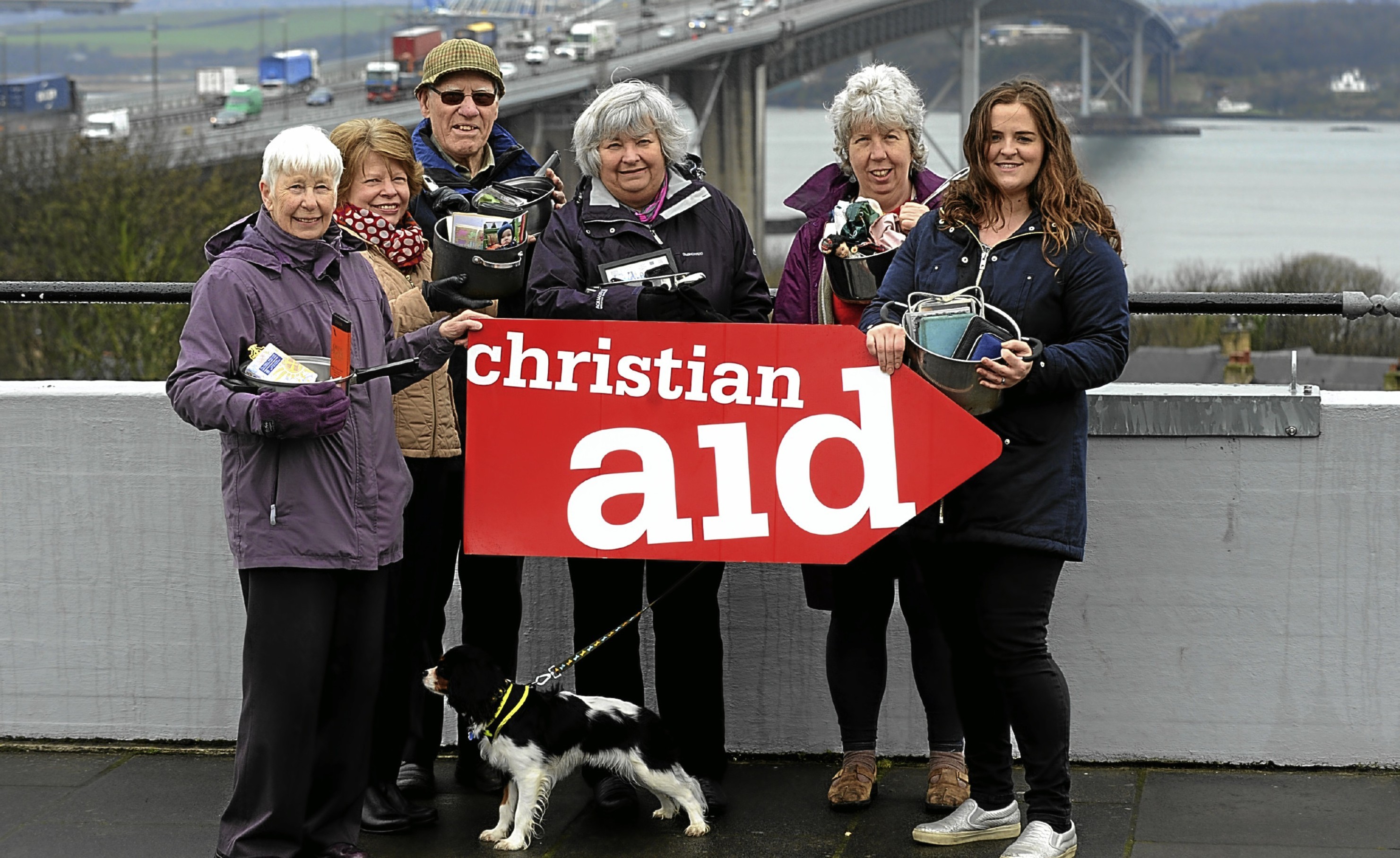 Christian Aid fundraisers Annette Carrie, Lesley MacKenzie, Tom Williamson, Gwenneth Williamson, Shenna Leslie, Amy Menzie with cooking pots which carry their most precious items. In Bangladesh, when homes flood people put their most precious items in their cooking pots to save them.The sponsored Forth Bridge Cross is 23rd April.Christian Aid Week starting the 15th May is raising funds for poor communities around the world including those in Bangladesh.