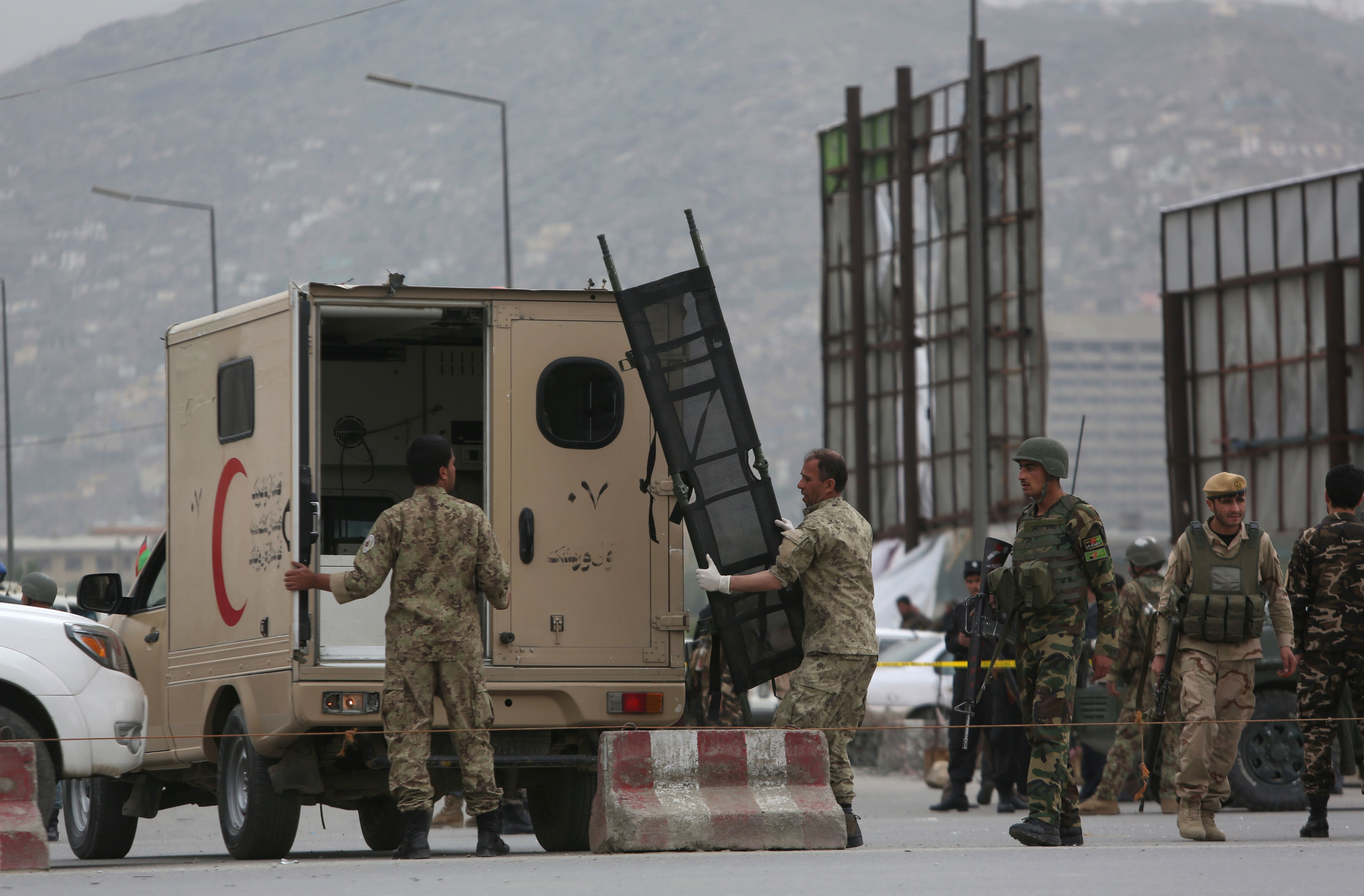 An Afghan medic carries stretcher after a Taliban-claimed suicide attack in Kabul.