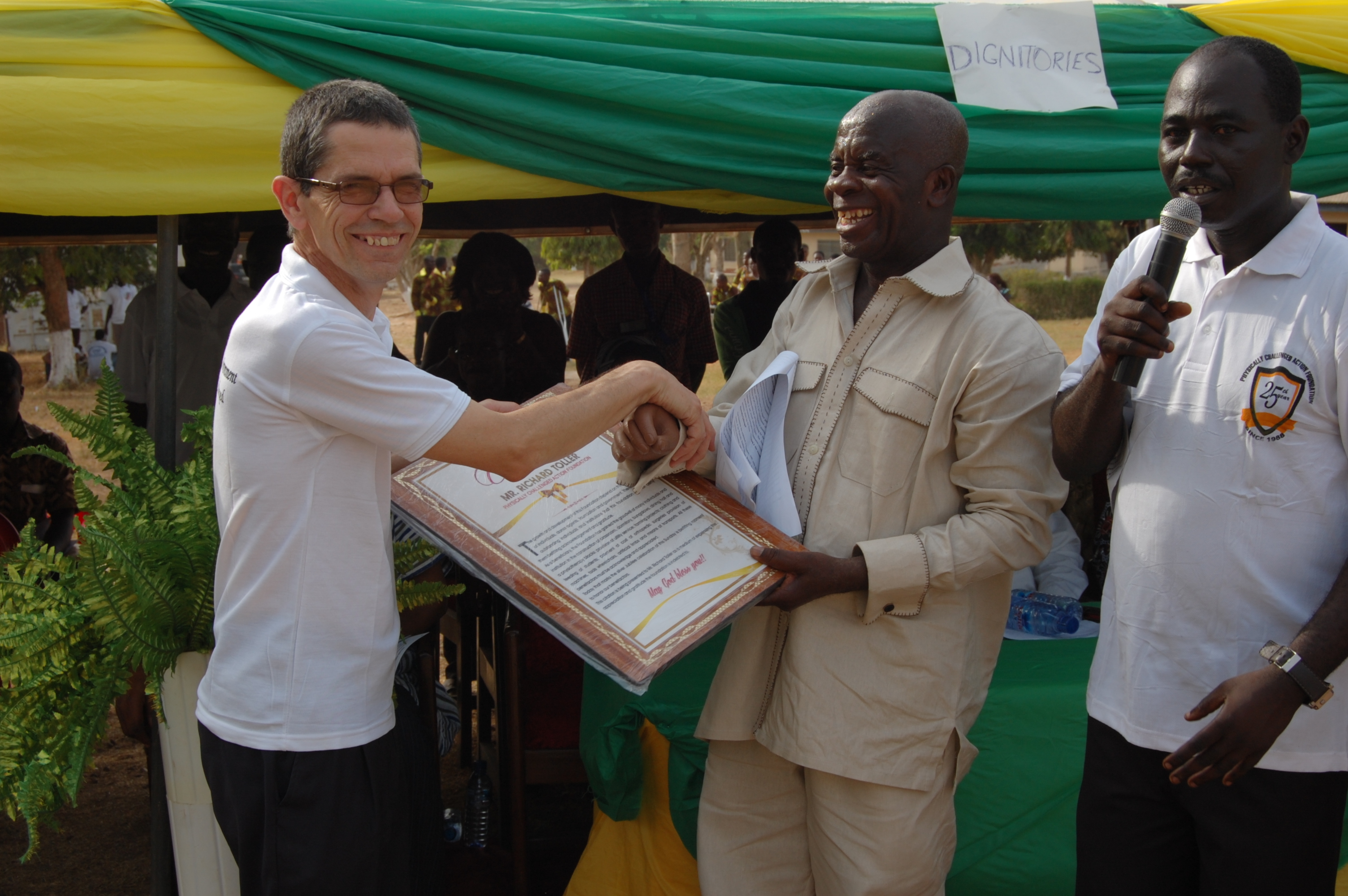 Richard receives a certificate of thanks from centre director Mr Antwi