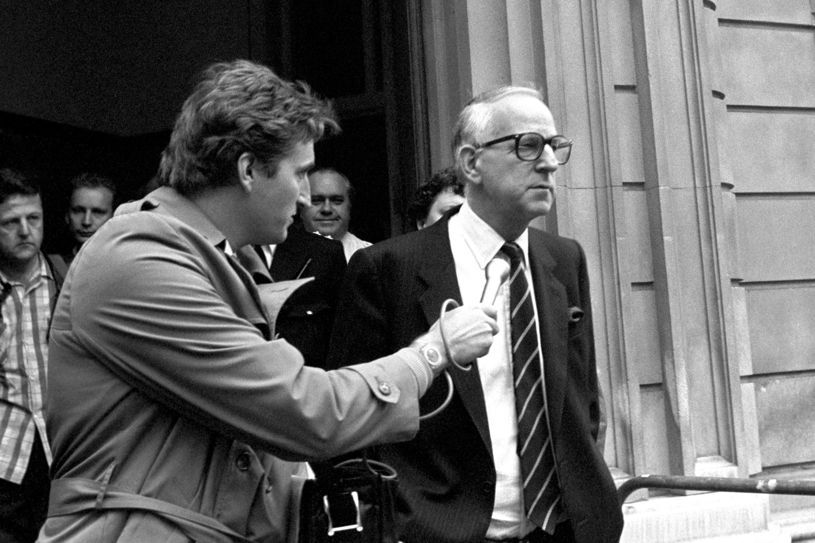 The former Guinness chairman, Ernest Saunders talks to reporters after an appearance at Bow Street Magistrates Court in 1987.