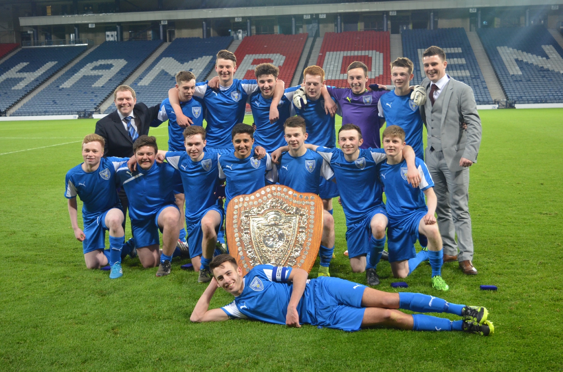 Senior pupils from St John's RC High School pose on the pitch at Hampden Park after their historic schools cup win.