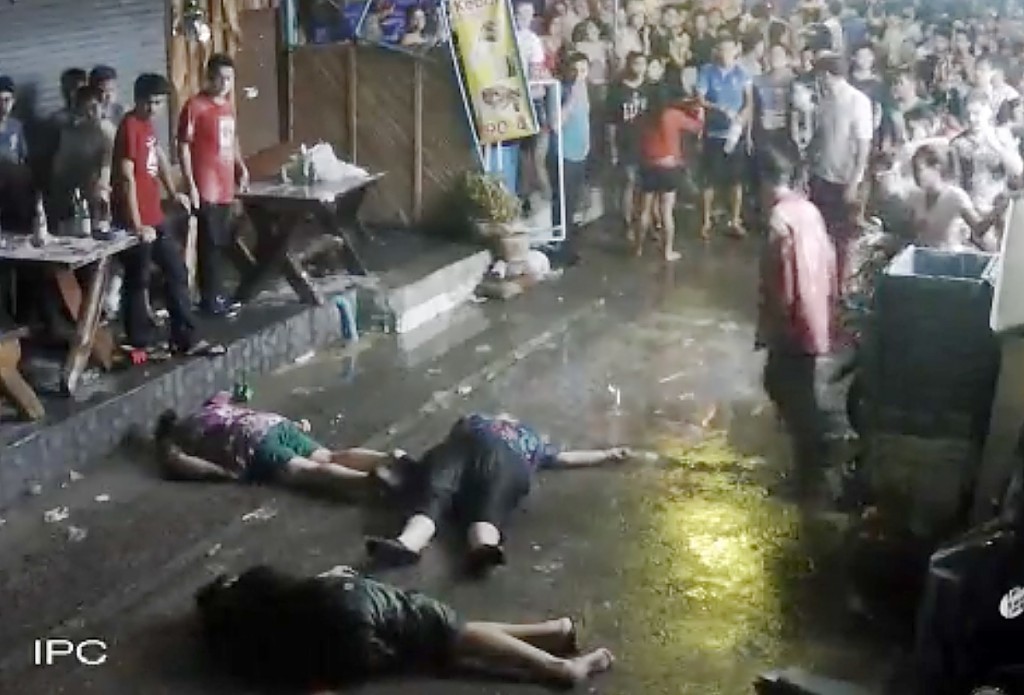 The elderly British couple and their son  on the ground after they were savagely attacked during a family vacation in Hua, Hin, Thailand. 