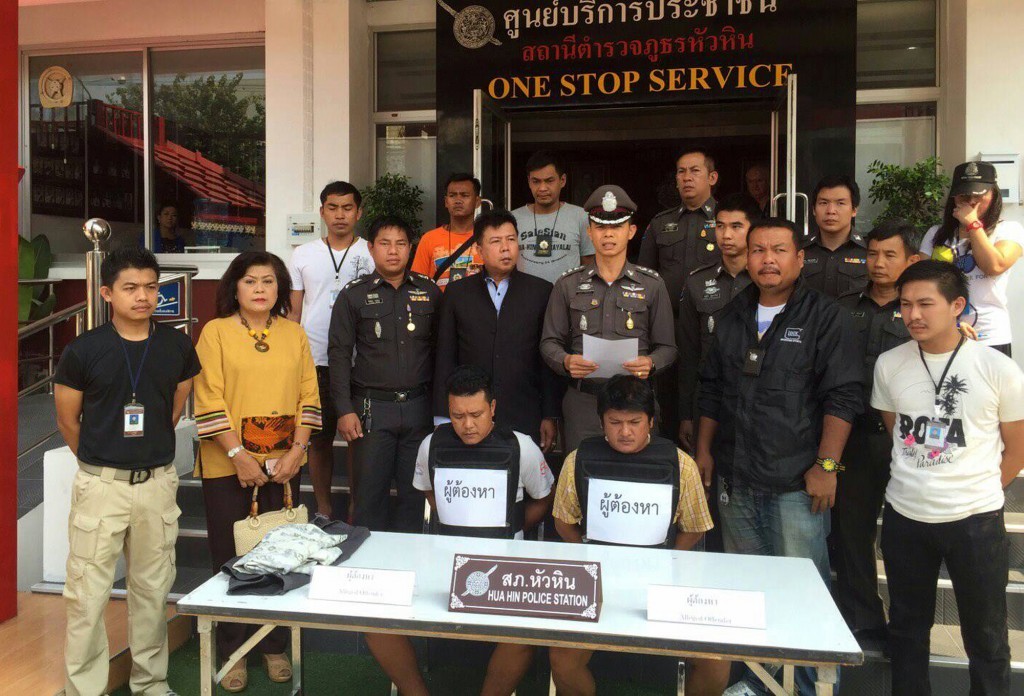 Hua Hin police stand behind two suspects,  who were arrested following the assault .
